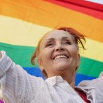 Image of Senior with Rainbow Flag